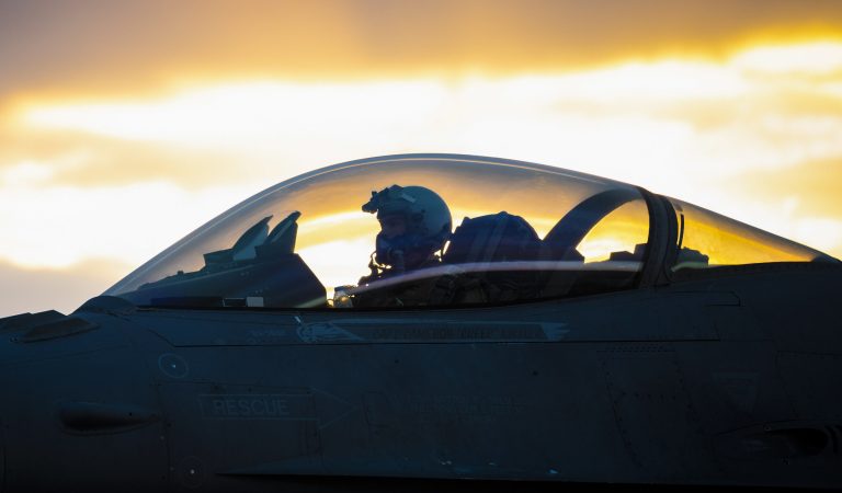 An Air Force F-16C Fighting Falcon pilot waits on the flightline