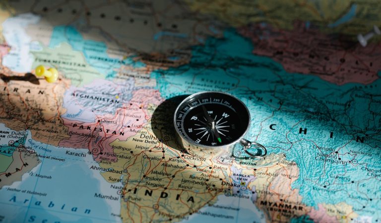 A compass sitting on top of map of the Indo-Pacific region